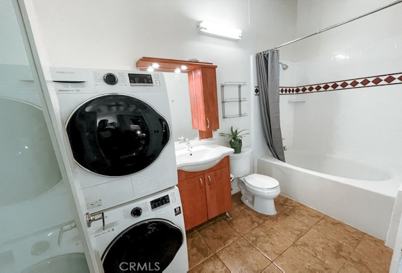 Bathroom with washer/dryer & shower in the soaking tub.